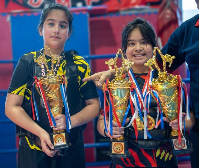 Two young DMA champions holding trophies