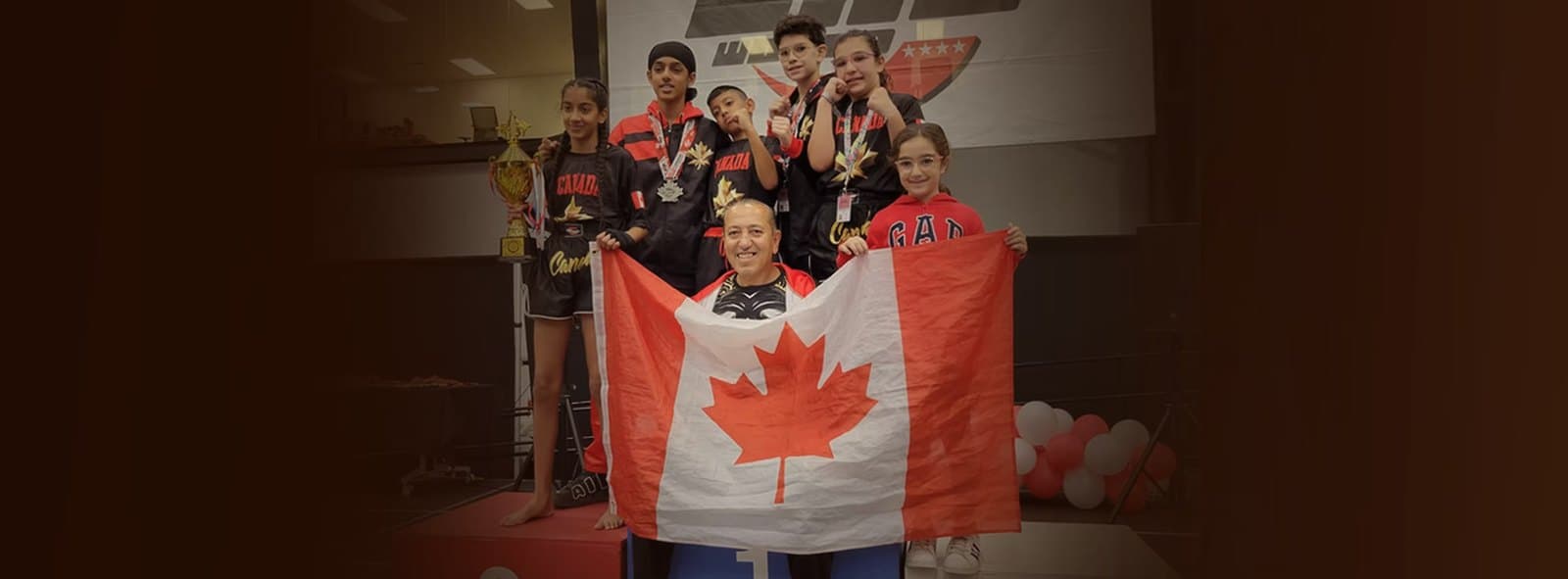 DMA Academy's Team Canada young athletes with Master Damerji, medals and a trophy